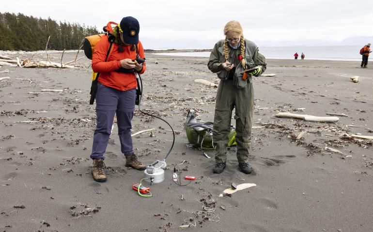 Graduate student researchers Claire Puleio and Valerie Wasser of the UAF Geophysical Institute take ground carbon dioxide measurements and ground and atmospheric readings on a Kruzof Island beach. Photo by JR Ancheta.
