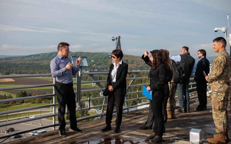 U.S. Undersecretary of Defense Heidi Shyu, center, listens to Alaska Satellite Facility Director Wade Albright on top of the Elvey Building on Aug. 24. Shyu toured the Elvey Building and also the Alaska Center for Unmanned Aircraft Systems Integration hangar. UAF/GI Photo by Courtney Holtzclaw.