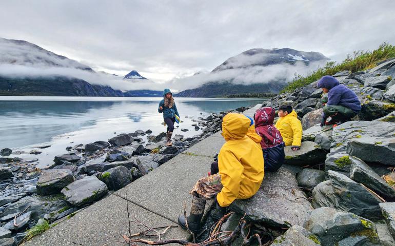 Serina Wesen of the Geophysical Institute teaches a small group of students about glaciers and how they formed the surrounding valley and Portage Lake. Photo courtesy KMTA.