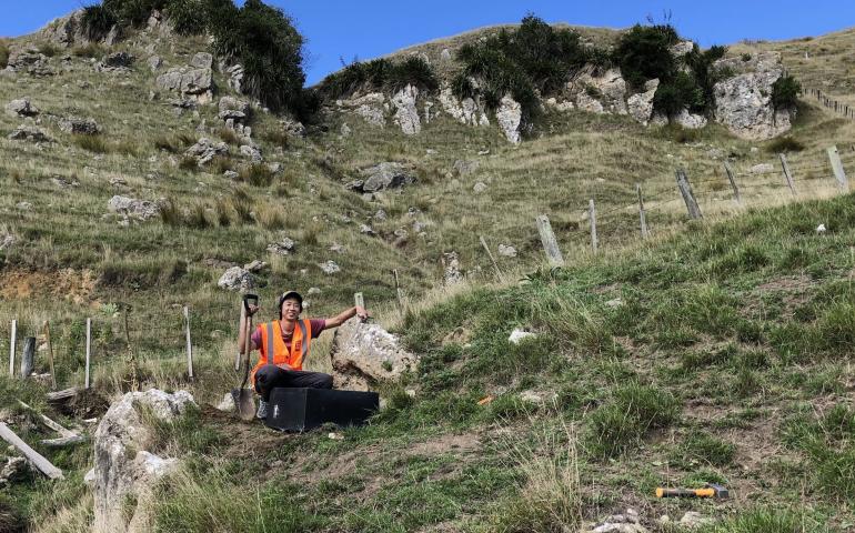 Bryant Chow in front of a seismic station deployed in Hawke's Bay, New Zealand. This station was part of the Broadband East Coast Network, which was deployed to improve data coverage for his imaging research. Photo courtesy Bryant Chow.