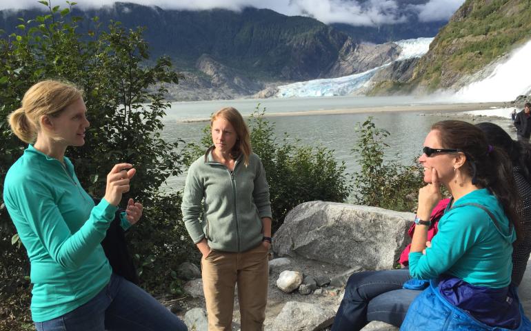 Laura Conner (left) in discussion with Laura Oxtoby and Suzanne Perin, both postdocs, discussing Bright Girls activities at the Mendenhall Glacier near Juneau. Photo by Cathy Connor