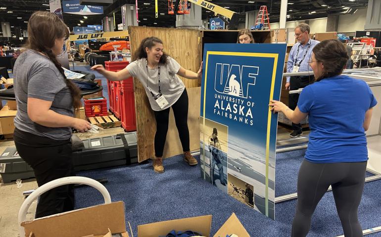 Setting up the UAF Research booth. Photo by Rod Boyce