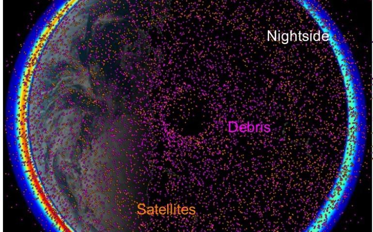 This image, with Earth’s north polar region at center, shows satellites (orange dots) and space debris (pink dots) in orbit through the ionosphere on July 22, 2024. Ionosphere model data were provided by Joseph Huba of Syntek Technologies in Virginia. Image courtesy of Paul Bernhardt