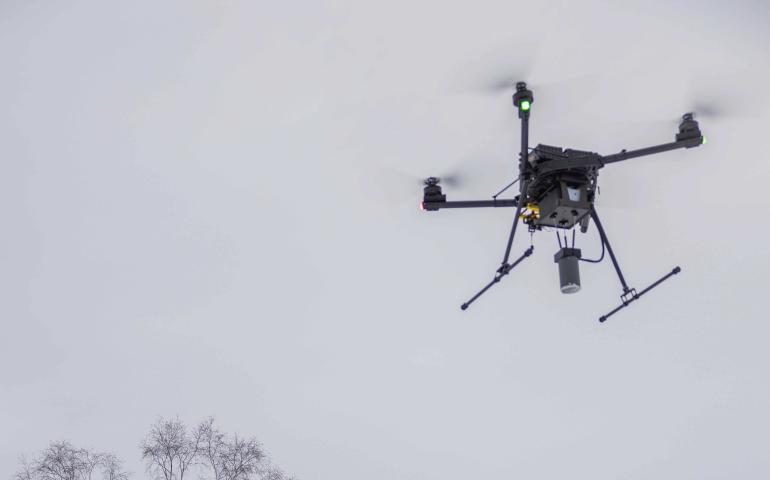 Chief pilot Jason Williams of the Alaska Center for Unmanned Aircraft Systems Integration, at right, controls a drone carrying the science instruments during a test flight Jan. 17, 2025. Research assistant professor Társilo Girona watches. Photo by Eric Marshall