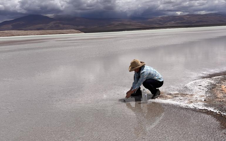 Lee Ann Munk samples the surface at a closed-basin brine in Argentina in 2023. Photo courtesy of Lee Ann Munk