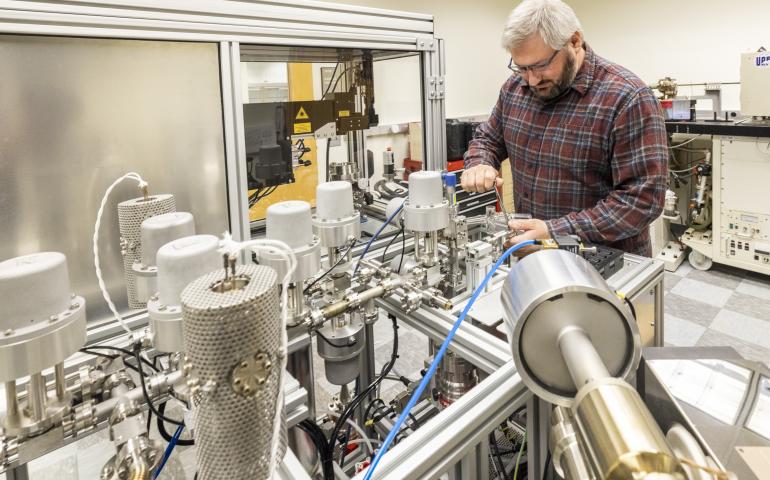 Research assistant professor Florian Hofmann of the UAF Geophysical Institute’s Geochronology Lab works on the lab’s argon mass spectrometer. Photo by JR Ancheta