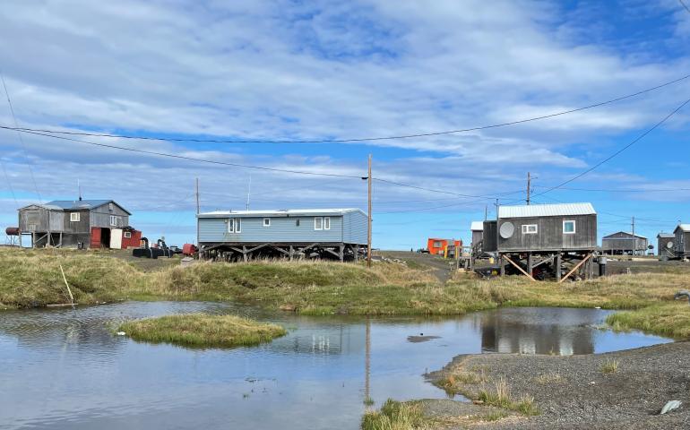 Most of Point Lay’s residential area sits on permafrost that is rapidly thawing. The subsiding ground exposes more of each building’s support pilings. UAF photo by Benjamin Jones