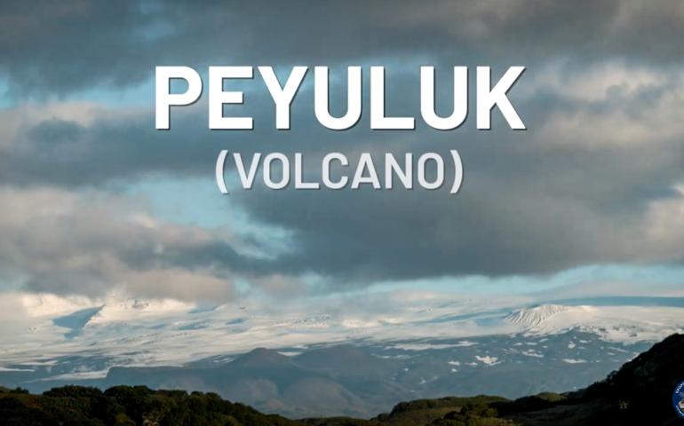 Landscape photo of a large volcano with the words "PEYULUK (VOLCANO)" superimposed on the image
