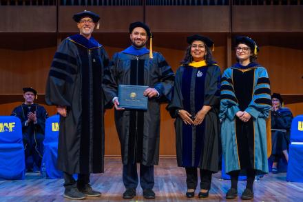 UAF Chancellor Dan White and Provost and Executive Vice Chancellor Anupma Prakash pose with Dillon Gillespie during the 2025 Ph.D. Hooding Ceremony in the Davis Concert Hall on the UAF campus, Friday, May 2, 2025. Gillespie earned a Ph.D. in Space Physics. He is escorted by Dr. Doğacan Öztürk, right. UAF photo by Eric Engman