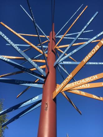 The International Signpost installation in front of the Elvey Building. Geophysical Institute photo by LJ Evans.