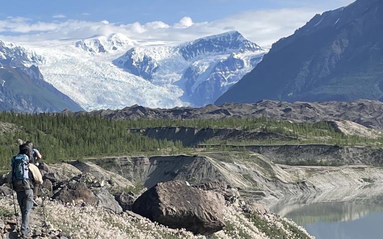 From left, Martin Truffer and Adam Bucki walk along the gravel moraine of Kennicott Glacier on an 11-hour hike to reach Fireweed rock glacier. Photo by Ned Rozell.