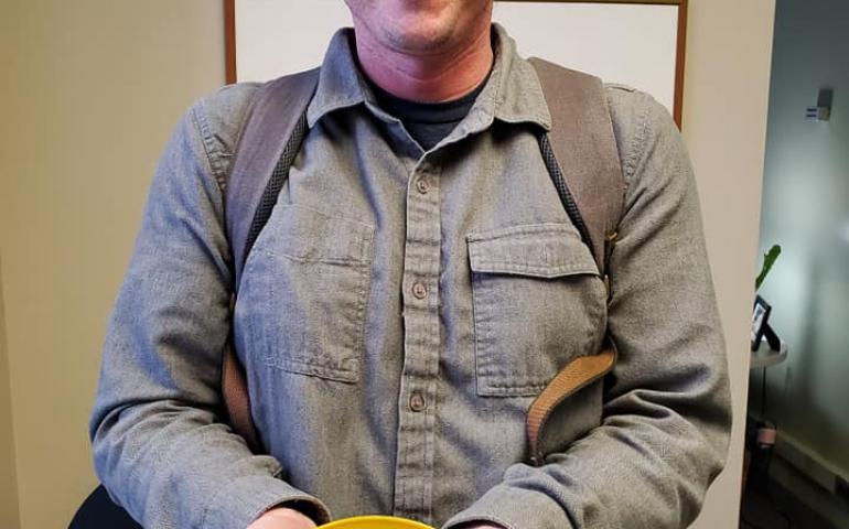 UAF’s Ben Jones with a plastic disc researchers released on northern sea ice 40 summers ago. A pilot working with Jones found it in August 2019, not far from where it was released. Photo by Fritz Freudenberger.