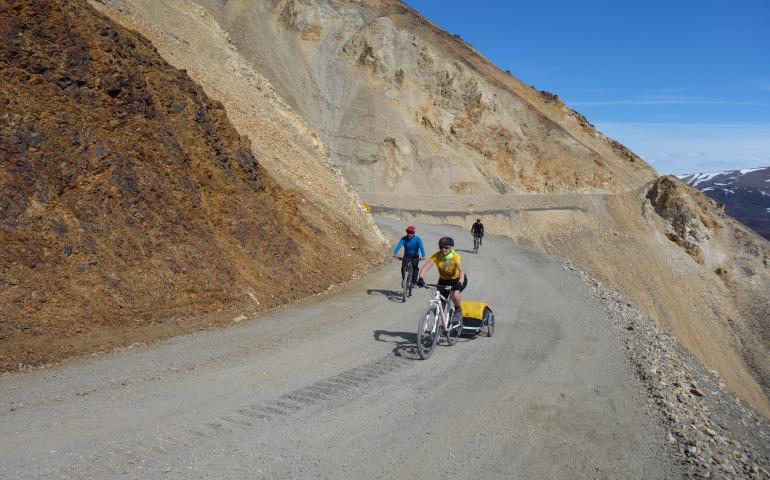 Cyclists ride an unstable portion of the 92-mile gravel road within Denali National Park. Photo by Ned Rozell.