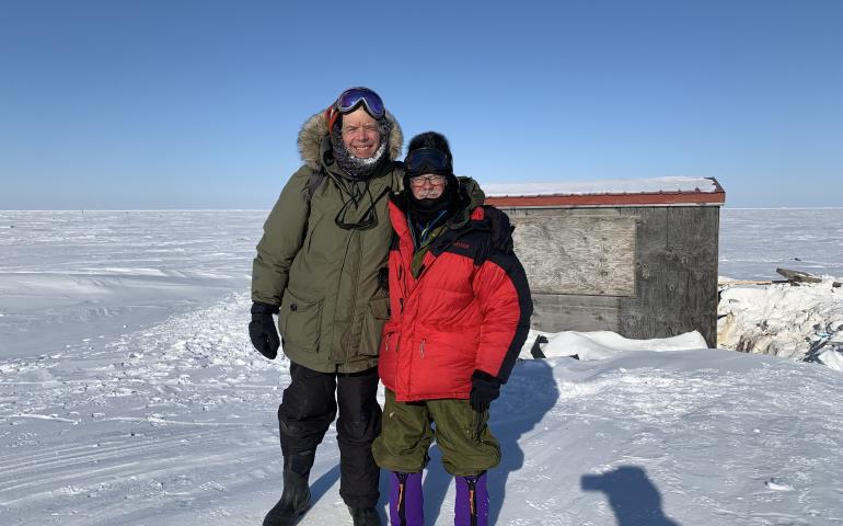 George Divoky and his friend Matt Thomas pose in front of Divoky’s cabin on Cooper Island after repairing polar-bear damage in April, 2022. Photo by Craig George.