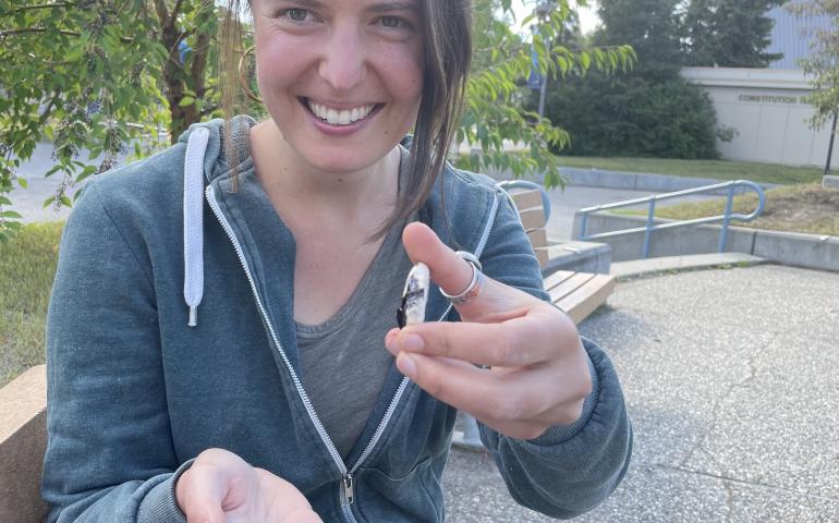 Kelsey Aho shows ceramic tiles she created from minerals gathered around Alaska. Ned Rozell photo.