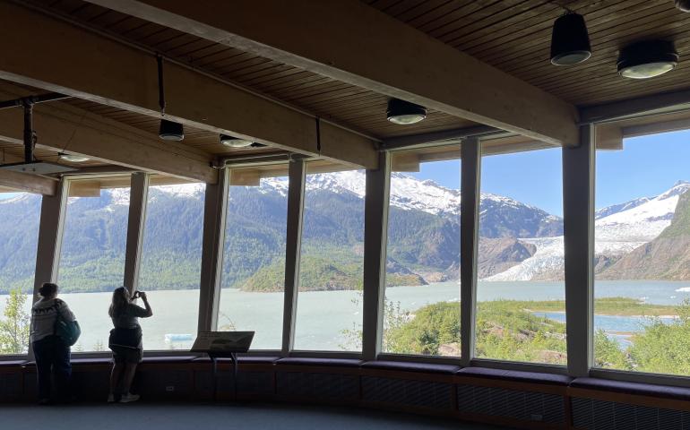 Visitors take images of Mendenhall Glacier near Juneau in summer 2022 from inside the Mendenhall Glacier Visitor Center. Photo by Ned Rozell.