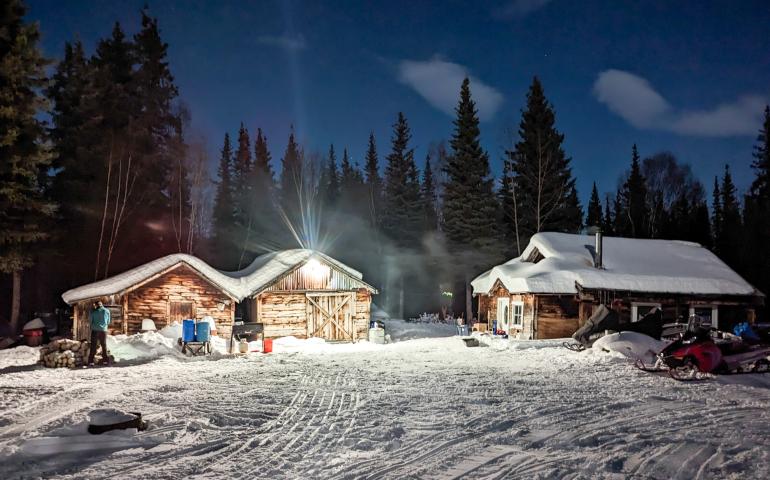 Iditarod checkpoint volunteers turned a light on in the ghost town of Ophir during the 2023 race. Photo by Jay Cable.