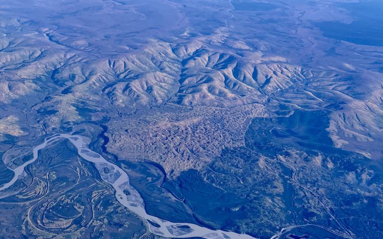 A vegetated sand dune that formed between the Tanana River, Interior Alaska hills and the Taylor Highway, as seen from a flight from Seattle to Fairbanks. The Alaska Highway Bridge over the Tanana River is visible at bottom. Photo by Ned Rozell.