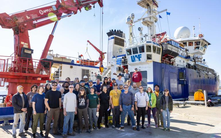 Researchers and crew members pose beside the University of Alaska Fairbanks research ship Sikuliaq in Dutch Harbor during a 2023 cruise to the Bering Sea to learn more about the Bering Land Bridge. Photo by JR Ancheta.