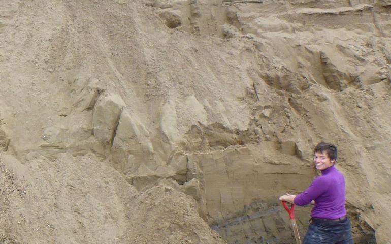 Louise Farquharson, a postdoctoral researcher at UAF’s Geophysical Institute, digs into an ancient beach on the north shore of Teshekpuk Lake. Photo by Guido Grosse.