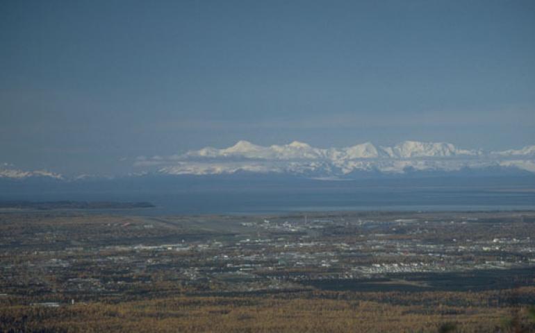  Photo: Mount Spurr, the tallest of the mountains in this photo taken from the hills east of Anchorage, blacked out the city with ash 50 years ago in the first interaction between a volcano and urban Alaska. Photo by Game McGimsey. 