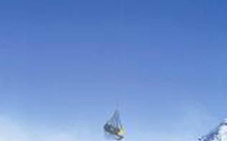  A helicopter pilot sling-loads supplies to a saddle between Mounts Bona and Churchill in eastern Alaska where Ohio State scientists pulled extracted a quarter-mile of ice. Lonnie Thompson photo. 