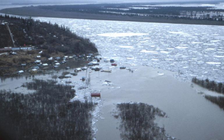  An ice jam in the lower Yukon backed the river into the village of Russian Mission in 1989. Floodwaters remained in the village for one week, when the only way in or out was by helicopter. Photo by Larry Rundquist, Alaska-Pacific River Forecast Center. 