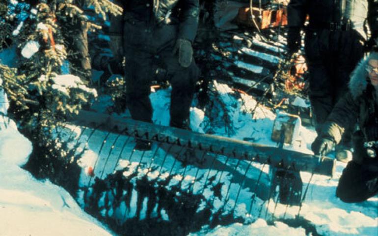 Scientists with the Cold Regions Research and Engineering Laboratory spill about 2,000 gallons of hot crude oil on the forest floor north of Fairbanks on Feb. 26, 1976. Terry McFadden photo. 