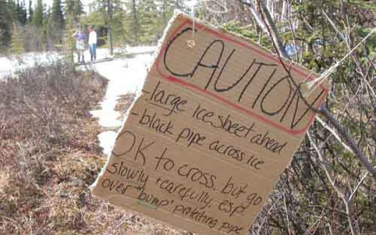  A resident of the Goldstream Valley north of Fairbanks installed this sign warning trail users of a small glacier that formed in her yard. Photo by Ned Rozell. 