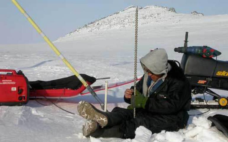  Kenji Yoshikawa drills a hole to monitor permafrost in the Seward Peninsula village of Wales. Photo by Ned Rozell. 
