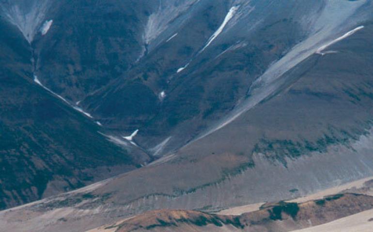  Hikers traverse the Valley of Ten Thousand Smokes on the Alaska Peninsula, walking on a sheet of ash and volcanic rock more than 500-feet-thick. Photo by Ned Rozell. 