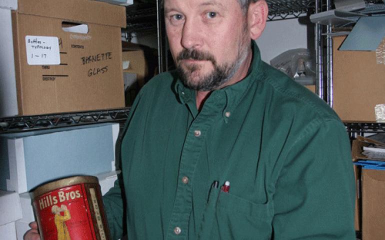  Bureau of Land Management archaeologist Steve Lanford with a Hills Bros. coffee can. BLM photo by Craig McCaa. 