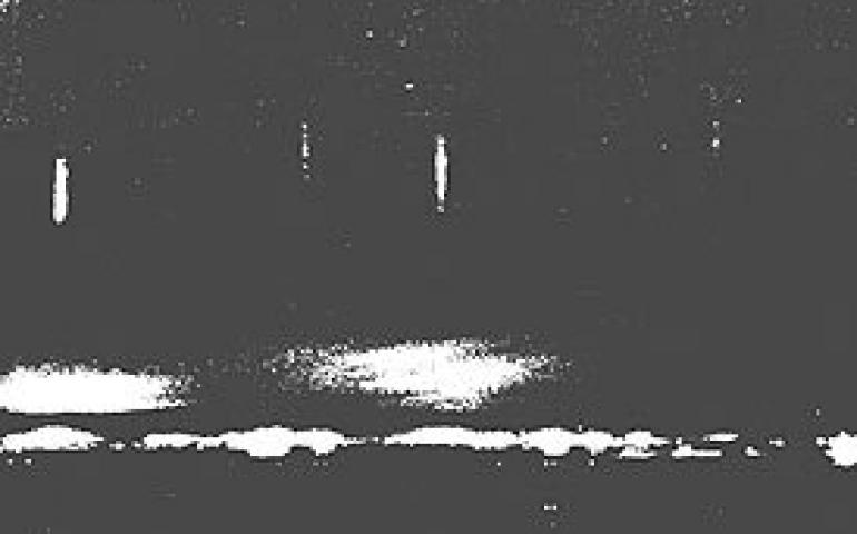 Partial vertical light shafts photographed in April 1978 by Mary Ford of the Peninsula Clarion. A combination of needle- and plate-like ice crystals falling over the industrial area north of Kenai has created these images which are akin to both vertical light shafts and sun dogs.