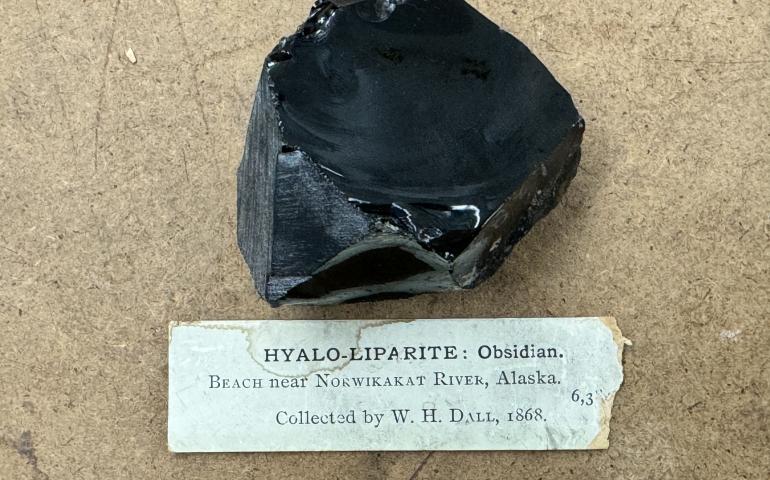 A piece of obsidian rock sits in the Smithsonian Institution in Washington, D.C. William Healey Dall collected the rock in 1868 near the Nowitna River in Interior Alaska. Exhibit No: NMNH 6384. Photo by Jeff Rasic.
