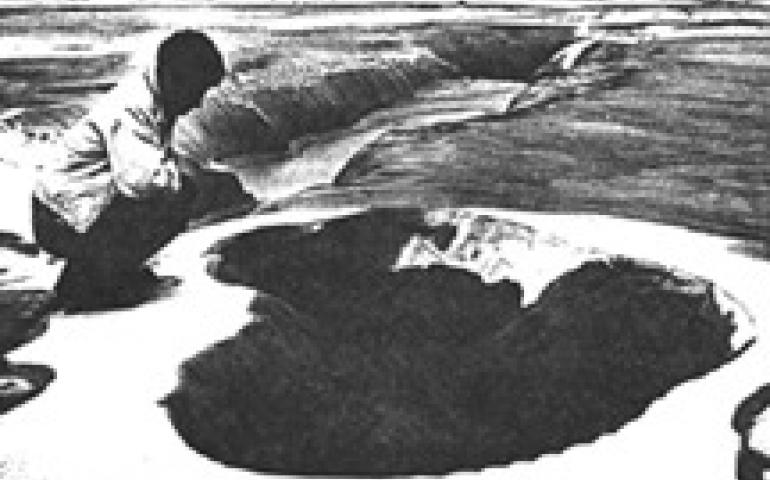  Bush pilot Donald E. Vent inspects a crater left by a sandblow near Yakutat. Flooding of the area during the eruption of the sandblows has coated the areas with a layer of silt and sand, including the fissure just beyond the sandblow.