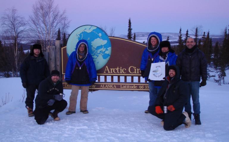 From left, Ryan West, Shawn Freitas, John Whittington, Doug Morrow, Bernie Tao, Darrin Marshall, and Andy Soria pose at the Arctic Circle pull-out on the Dalton Highway, where they camped in March 2009 to test the cold-weather performance of “Permaflo Biodiesel.” Photo courtesy Darrin Marshall.