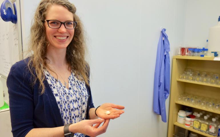 UAF graduate student Brittany Jones with the shell of a clam from the seafloor off western Alaska. Photo by Ned Rozell.