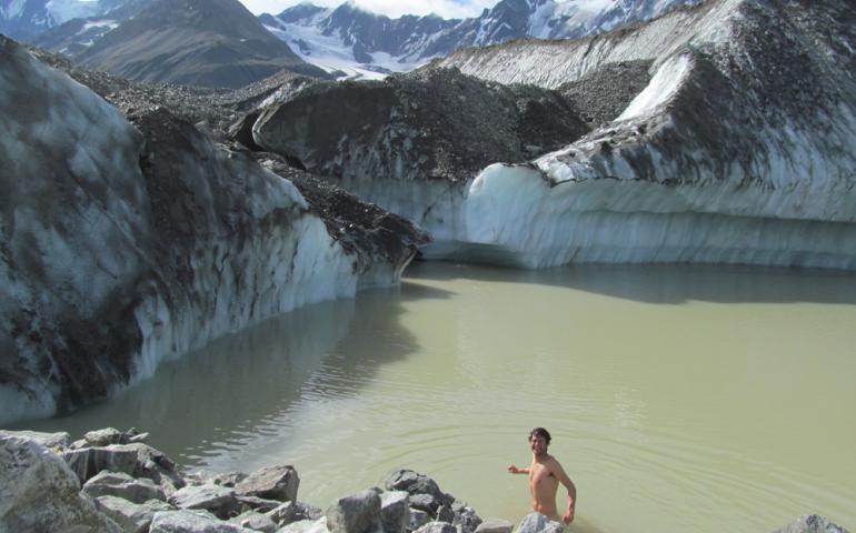 Glacier researcher Sam Herreid baths in a lake on Canwell Glacier in the eastern Alaska Range. Photo by Sam Herreid.