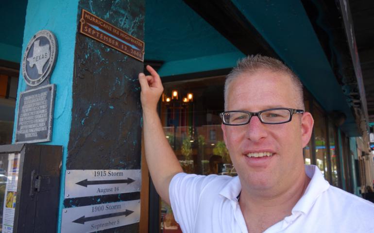 Hal Needham of the Galveston Historical Foundation shows the downtown water mark from Hurricane Ike’s storm surge in 2008. Ned Rozell photo.