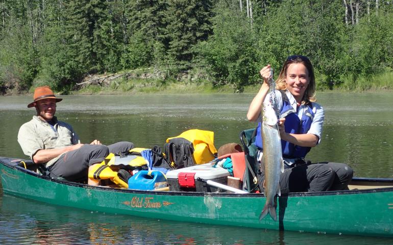 Alison Beamer displays a sheefish Jason Clark helped her land on the Zitziana River, which she paddled up on a Tanana River trip. Ned Rozell photo.