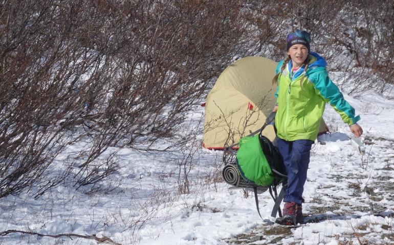 Anna Rozell exits the tent near Phelan Creek while joining her parents for nine days of hiking the path of the Trans-Alaska Pipeline. Photo by Ned Rozell