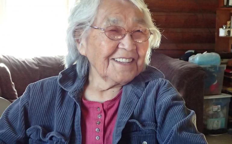 At her kitchen table in Minto, Alaska, 89-year-old Sarah Silas remembers a 1947 earthquake. Photo by Ned Rozell.