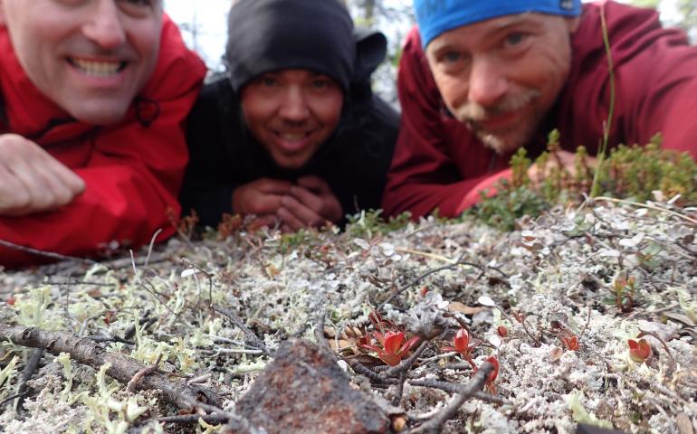 From left, Peter Jenniskens, Garrett Jones and Ned Rozell pose by an unusual rock they found near the Middle Fork of the Chandalar River. Photo by Ned Rozell.
