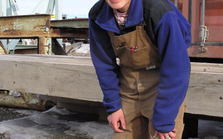 Raven researcher Stacia Backensto disguises herself as an oilfield worker in an attempt to fool ravens she has captured before. Photo by Jim Zelenak.