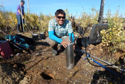 University of Alaska Fairbanks Ph.D. student Kyle Smith installs a seismic sensor in the Minto Flats on Sept. 3, 2015. Photo by Carl Tape