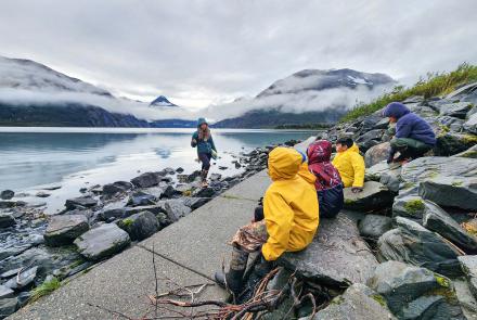 Serina Wesen of the Geophysical Institute teaches a small group of students about glaciers and how they formed the surrounding valley and Portage Lake. Photo courtesy KMTA.