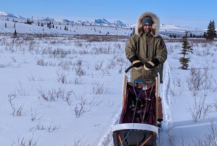 UAF doctoral student Kaytan Kelkar in Denali National Park in March for work on continuing permafrost research. Kelkar rode a sled towed by a National Park Service dog team. Photo courtesy of Kaytan Kelkar
