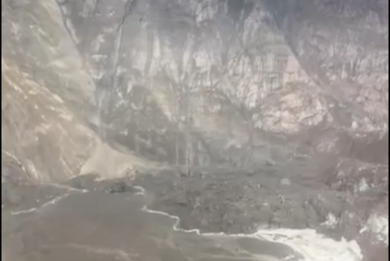 Debris from an Aug. 10, 2025, landslide in Southeast Alaska spilled into Tracy Arm and onto South Sawyer Glacier. Dirt, rock and debris now fill an area of the fjord in the lower left of the photo. Image from video by Lt. Chip Baucom and Cmdr. PJ Johansen, U.S. Coast Guard