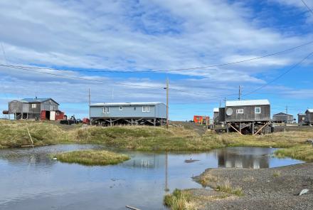 Most of Point Lay’s residential area sits on permafrost that is rapidly thawing. The subsiding ground exposes more of each building’s support pilings. UAF photo by Benjamin Jones