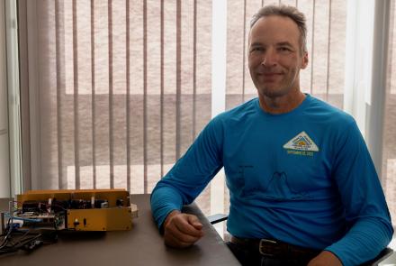 Associate research professor Carl Schmitt with the cloud particle imager he developed. Photo by Bryan Whitten 